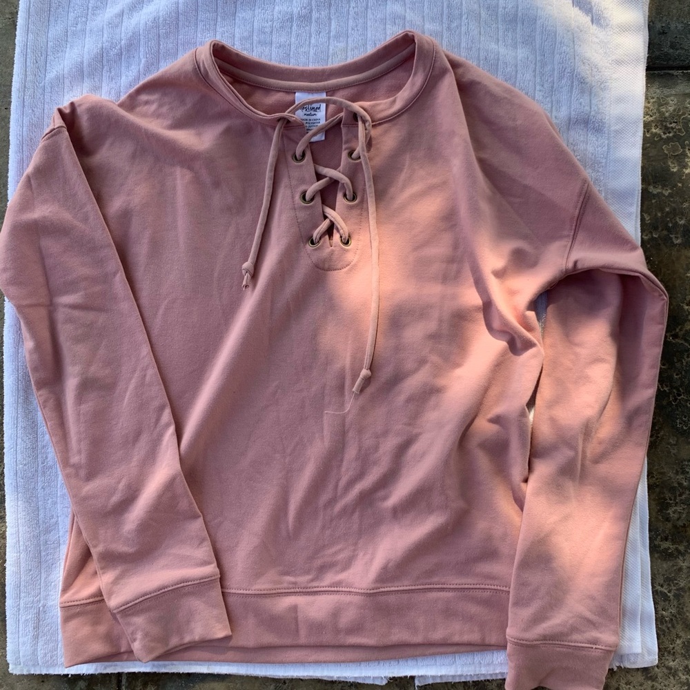 Pink sweatshirt with criss cross design